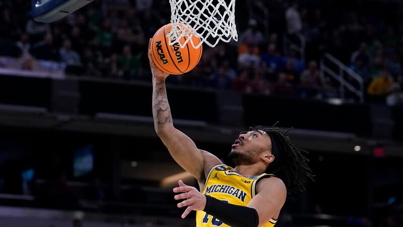 Michigan guard Frankie Collins drives to the basket during the second half of a college...