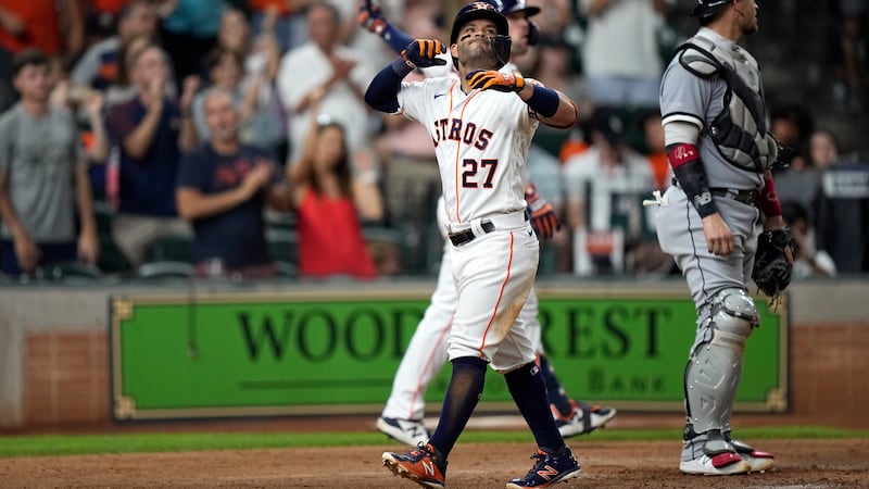 Houston Astros' Jose Altuve (27) celebrates after hitting a home run against the Chicago White...