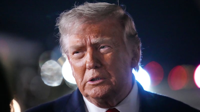 President Donald Trump talks with reporters before boarding Air Force One at John F. Kennedy...