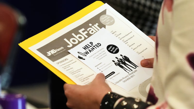 FILE - A job seeker waits to talk to a recruiter at a job fair Aug. 28, 2025, in Sunrise, Fla.