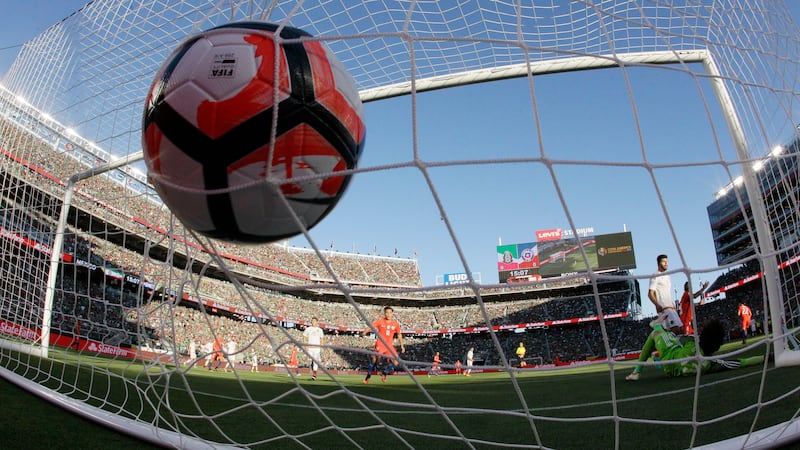 FILE - Mexico goalkeeper Guillermo Ochoa, bottom right, is beaten for a goal on a shot from...