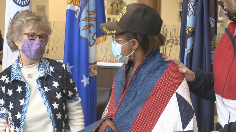 Retired Army Sgt. Eddie Whippen receives her Quilt of Valor.