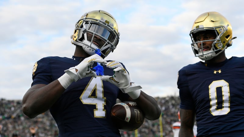 Notre Dame running back Jeremiyah Love (4) celebrates with teammate Malachi Fields (0) after...