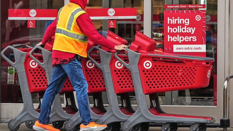 Signs for holiday hiring hang on the doors of a Target in Pittsburgh, Wednesday, Nov. 19, 2025.
