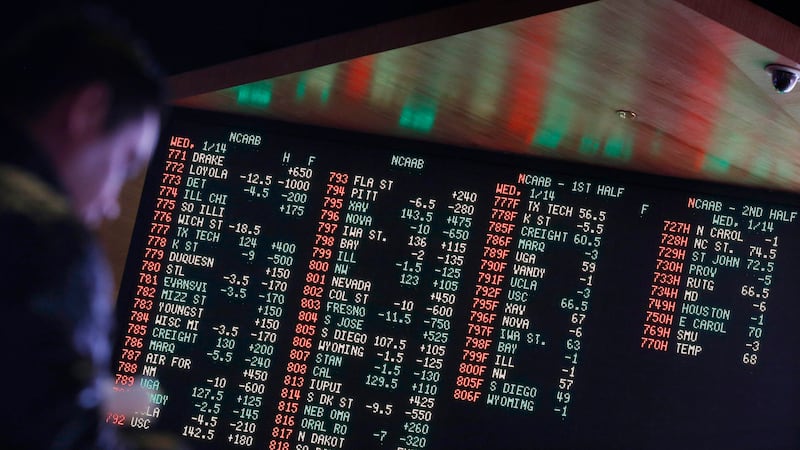 FILE - In this Jan. 14, 2015, file photo, odds are displayed on a screen at a sports book...