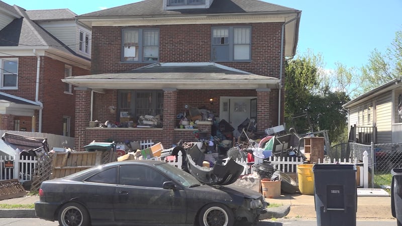The property on McDowell Avenue has trash and various items scattered all around the outside...