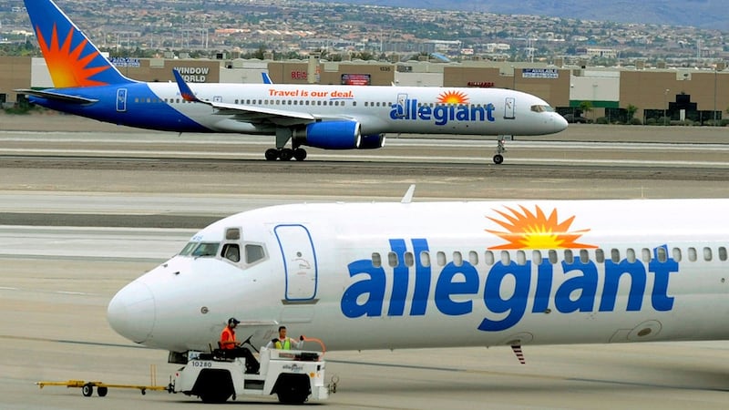 File - In this May 9, 2013, file photo, two Allegiant Air jets taxi at McCarran International...