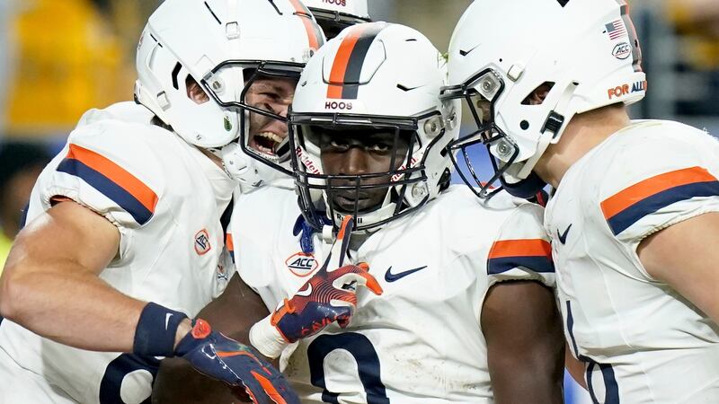 Virginia running back Xavier Brown (0) celebrates with wide receiver Eli Wood, left, and tight...
