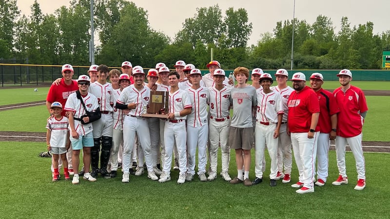 The Goshen High School baseball team poses with its sectional championship trophy on June 6,...