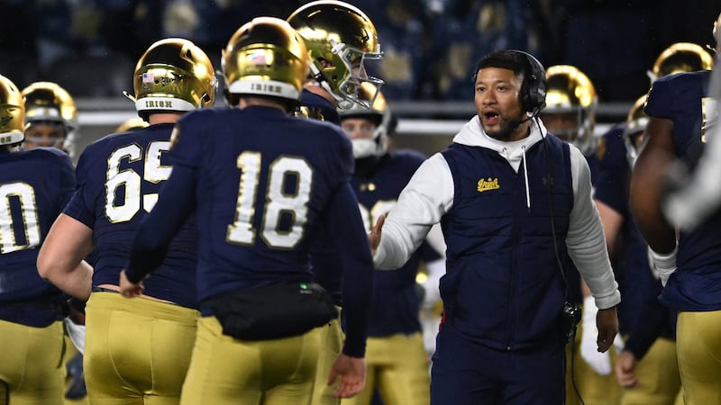 Notre Dame head coach Marcus Freeman, right, celebrates with kicker Erik Schmidt (18) on the...