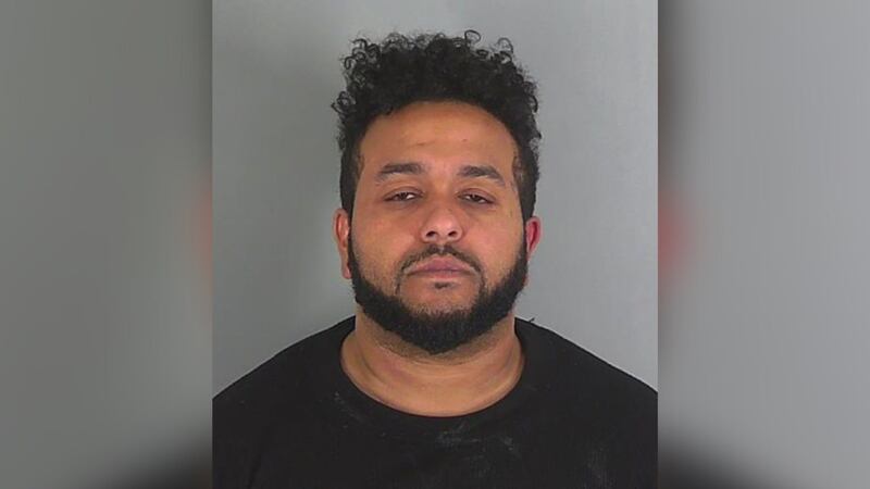 A man was arrested after police said they found him passed out in unlocked car with young child.
