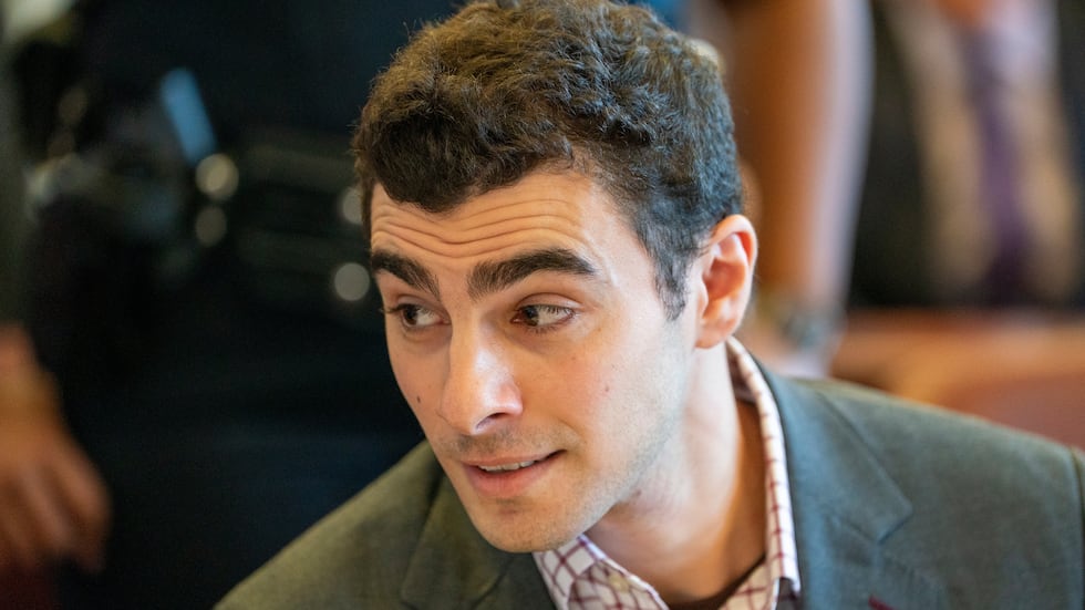 Luigi Mangione, center, appears in court for an evidence hearing, Monday, Dec. 1, 2025, in New...